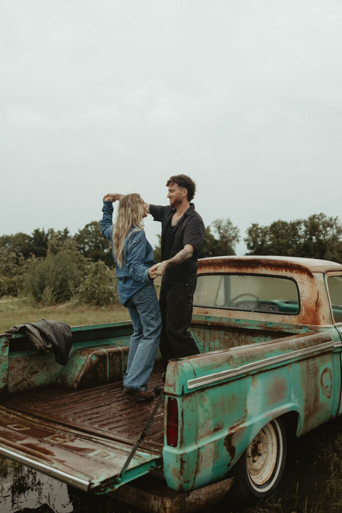 Couples dances in the back of a vintage truck during their couples session