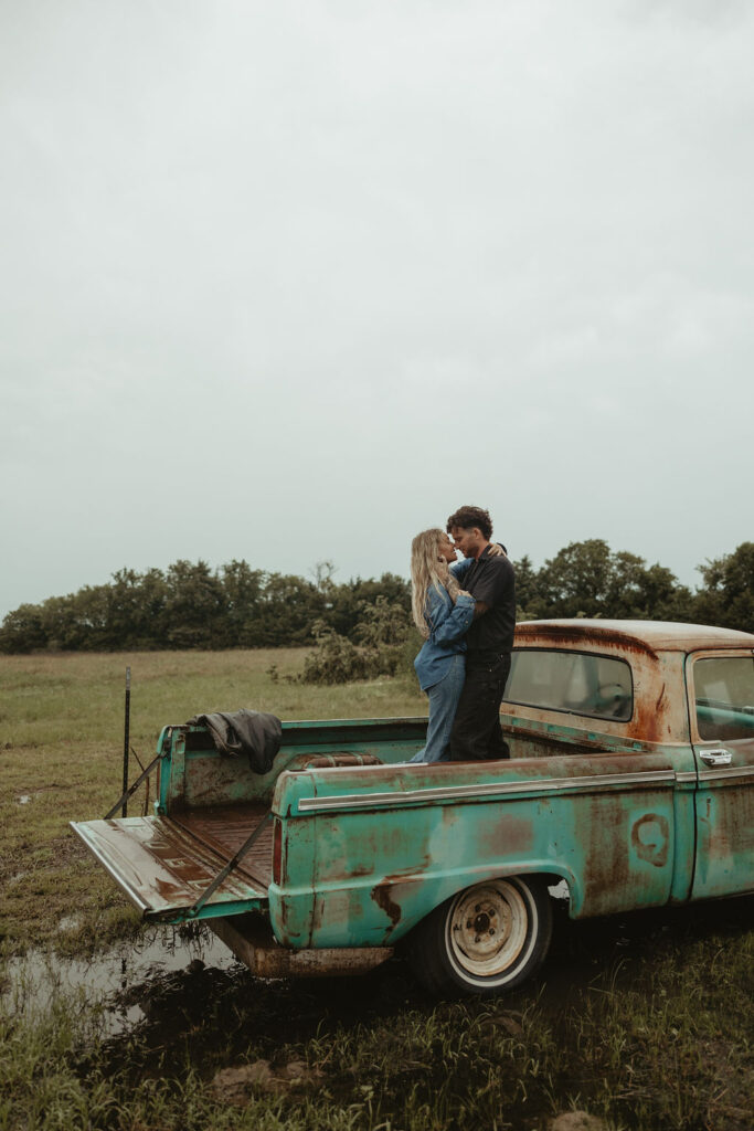 Couples dances in the back of a vintage truck during their couples session