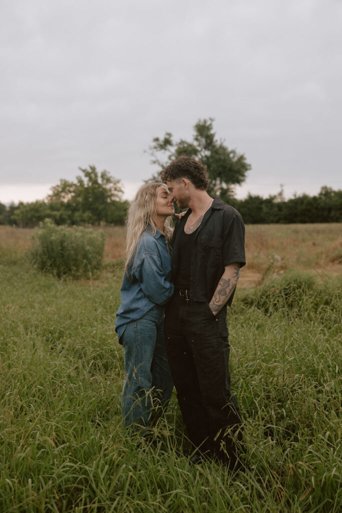 Couple stands in a Texas meadow for an intimate moment during their photoshoot