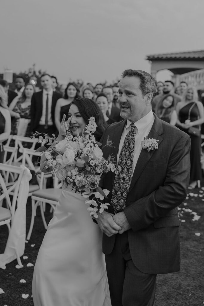 A tuscany-inspired wedding ceremony under a stone gazebo