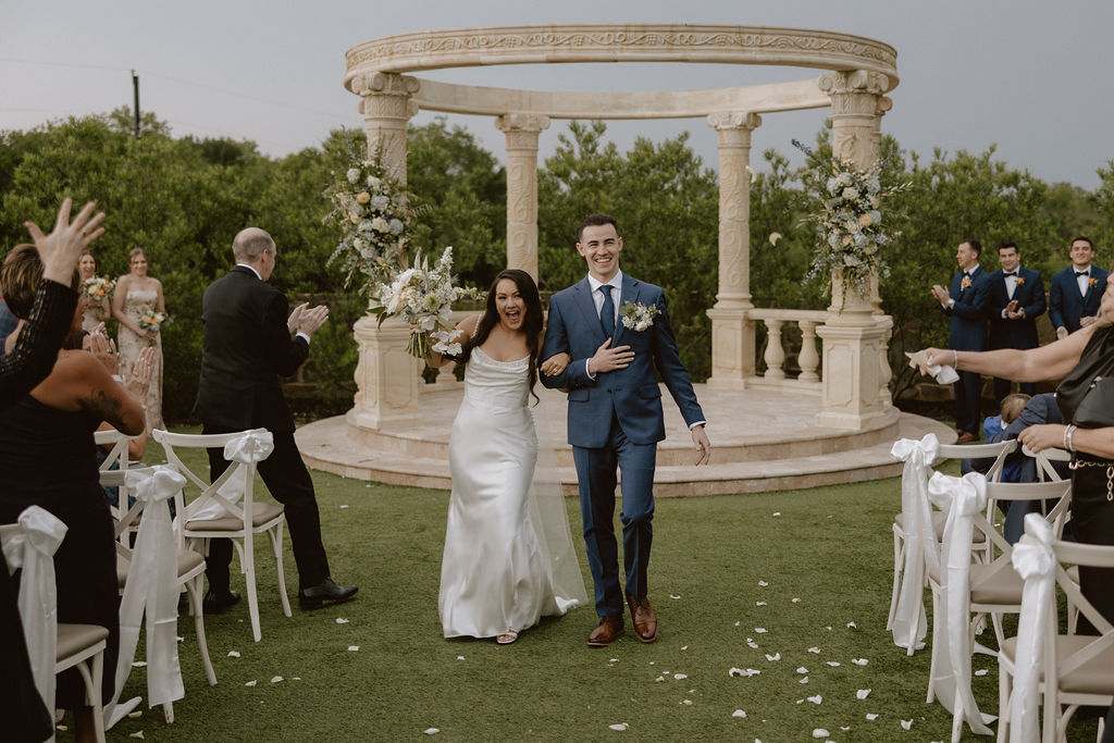 A tuscany-inspired wedding ceremony under a stone gazebo