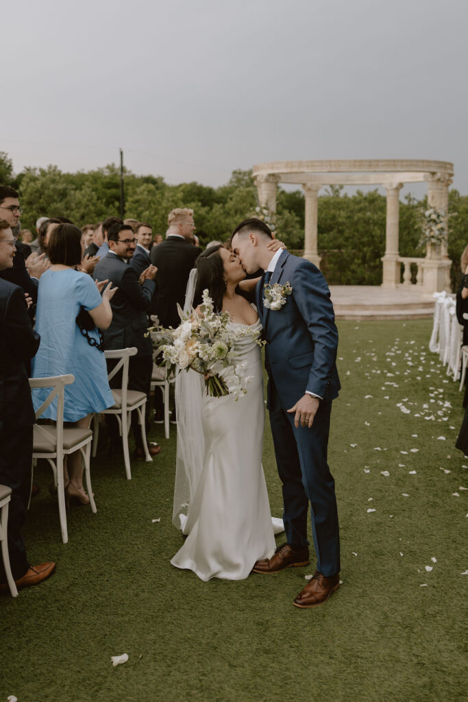 A tuscany-inspired wedding ceremony under a stone gazebo