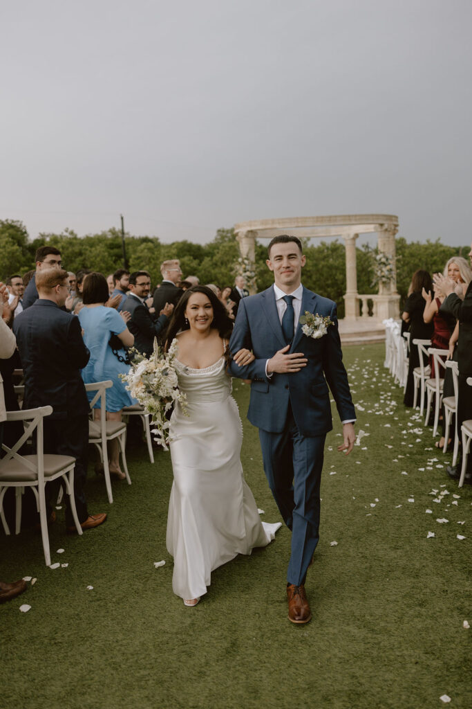 A tuscany-inspired wedding ceremony under a stone gazebo