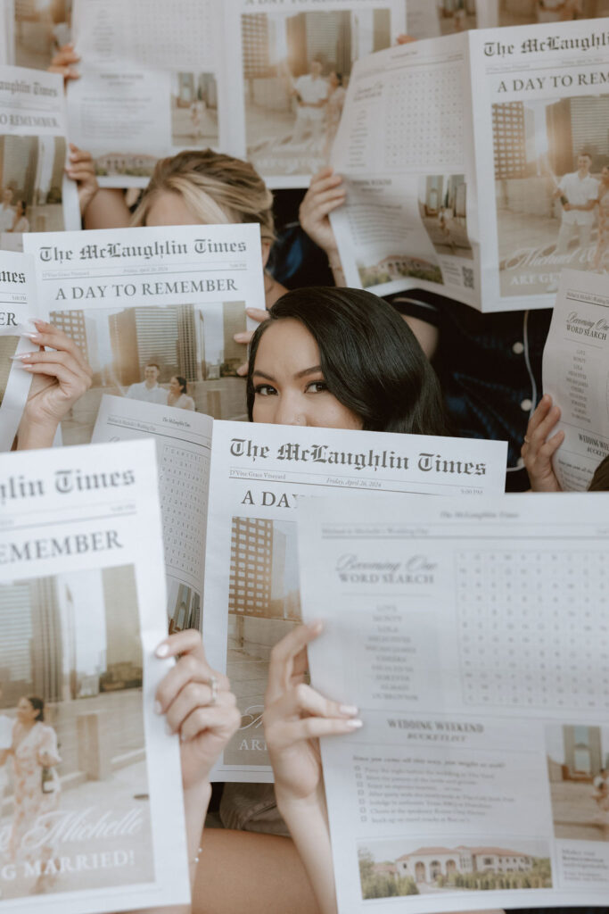 Bride and her bridesmaids with wedding newspapers