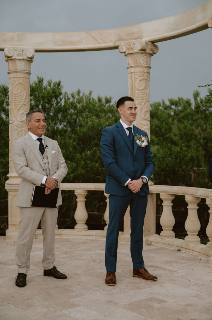 A tuscany-inspired wedding ceremony under a stone gazebo