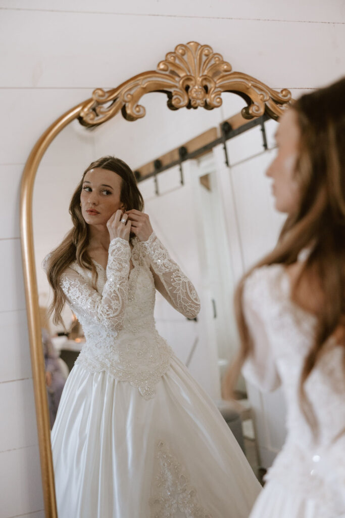 Bride getting ready in a vintage mirror