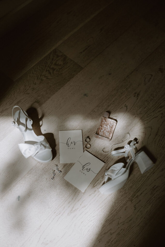 Elegant and simple white wedding details laid on the floor