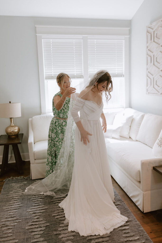 Mother helps bride get ready for her Eden Gardens State Park elopement