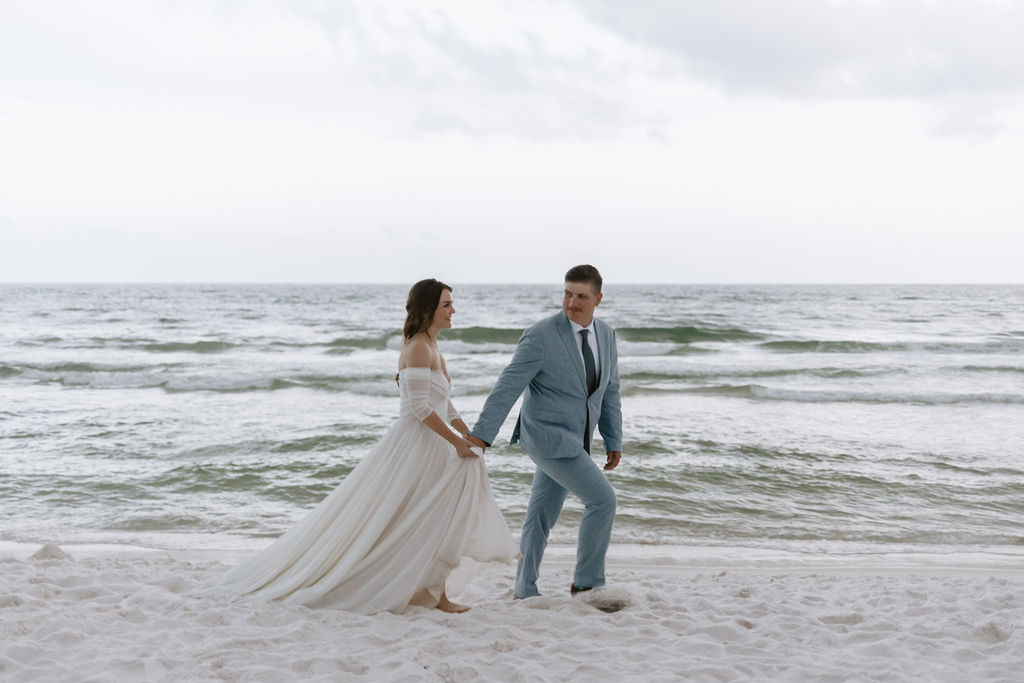 Bride and groom take photos on the beach in Destin, Florida after their Eden garden state park elopement