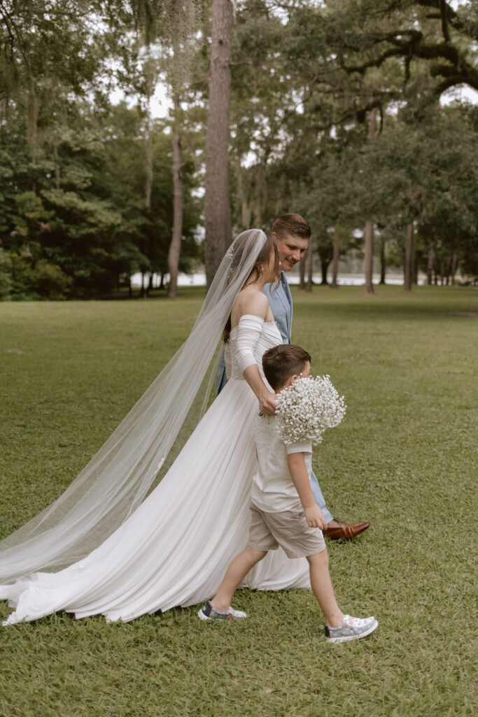 Bride and groom, leave their Eden Gardens state park elopement ceremony with their young son