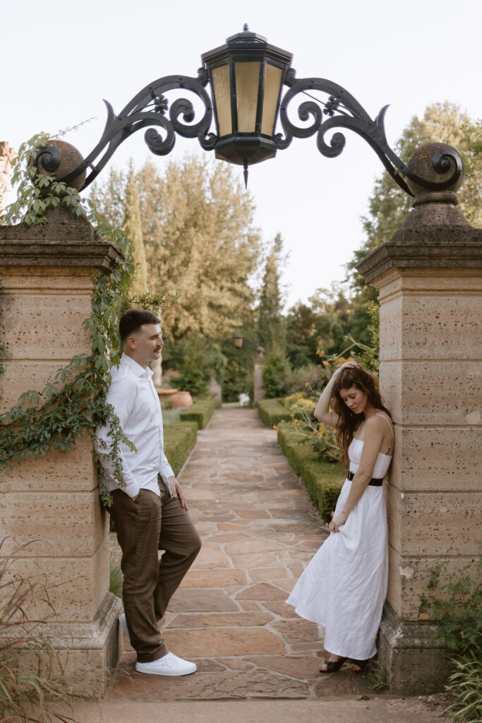 Man and woman stand on opposite sides of a lighted archway at Philbrook Museum of art