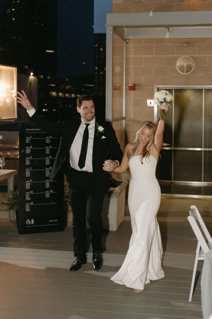 Bride and groom enter their Dallas rooftop wedding reception