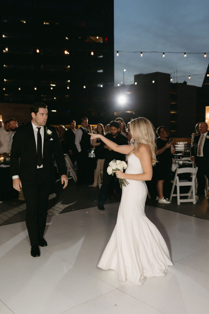 Bride and groom dance together during their Dallas rooftop wedding reception