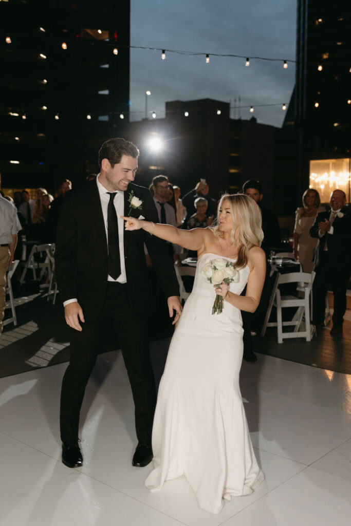 Bride and groom dance together during their Dallas rooftop wedding reception