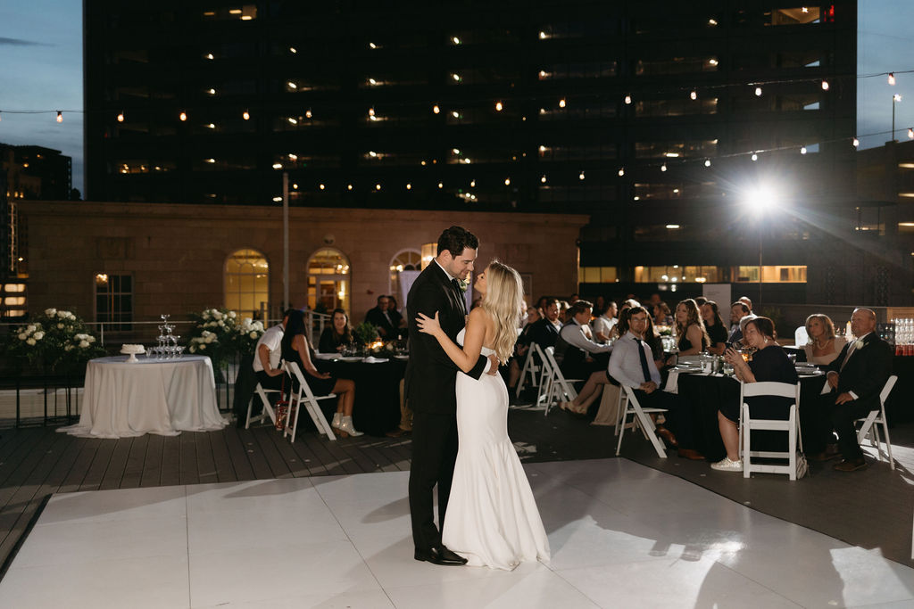 Bride and groom dance together during their Dallas rooftop wedding reception