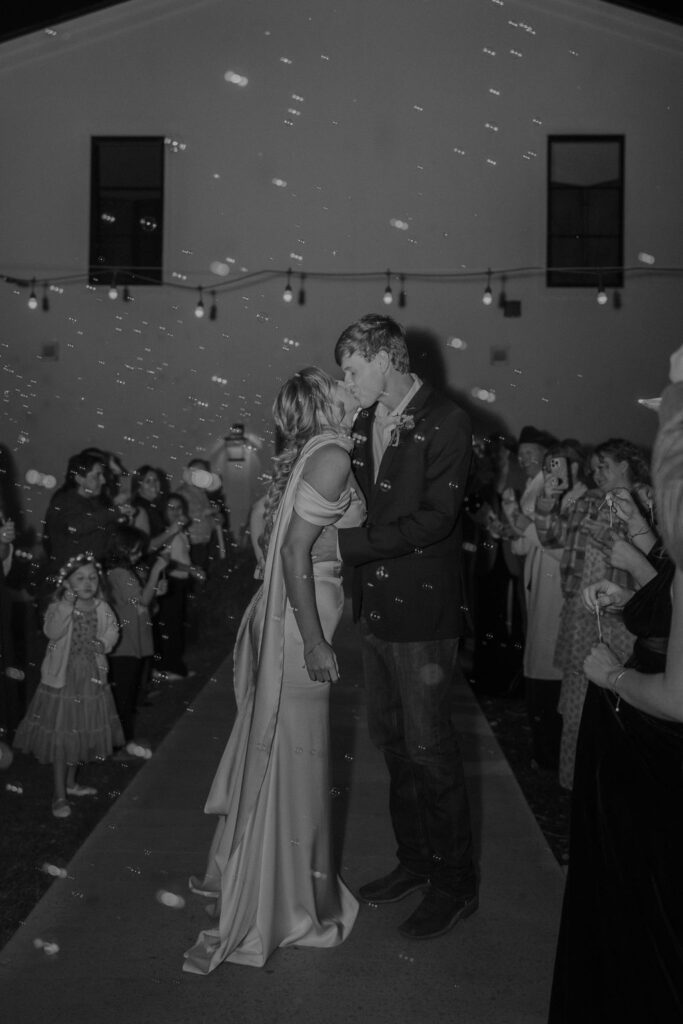 Bride and groom leave their Sorelle wedding reception with a bubble send-off