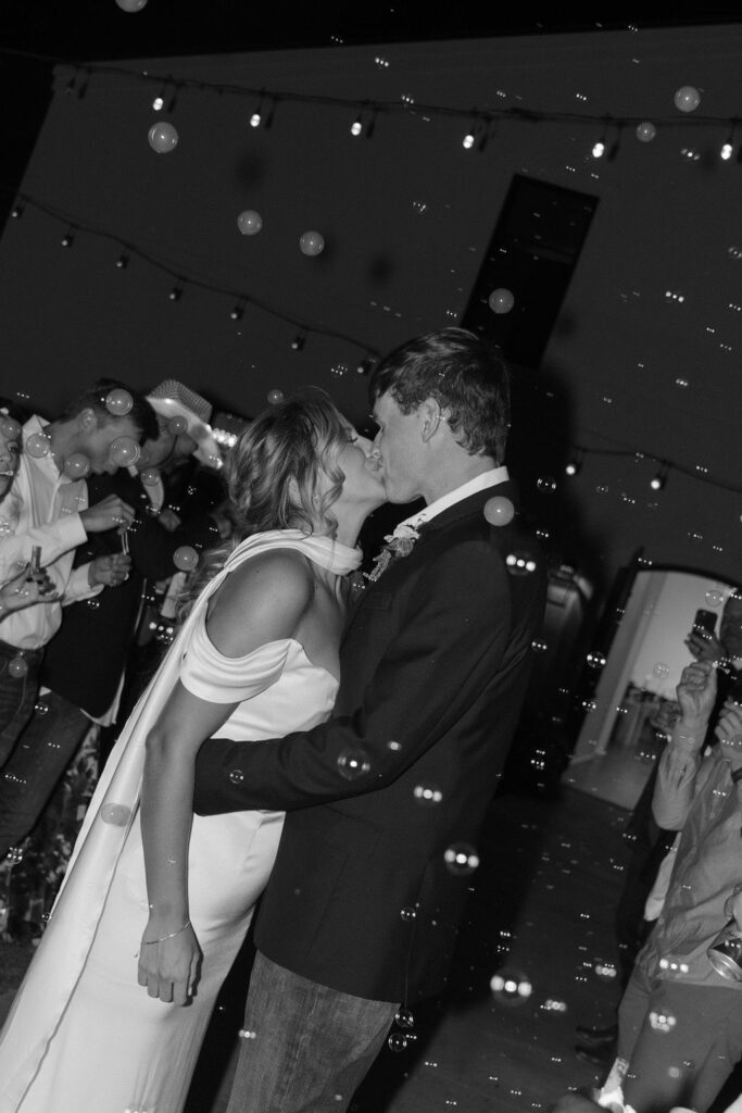 Bride and groom leave their Sorelle wedding reception with a bubble send-off