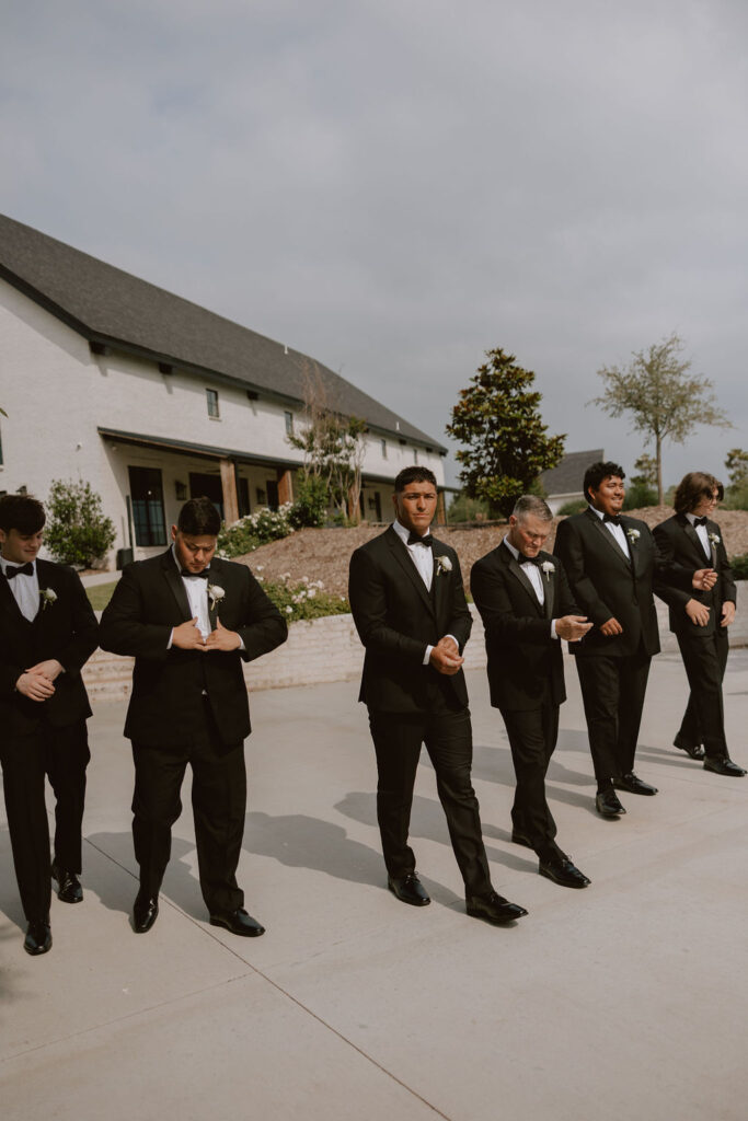 Groom walks with groomsmen