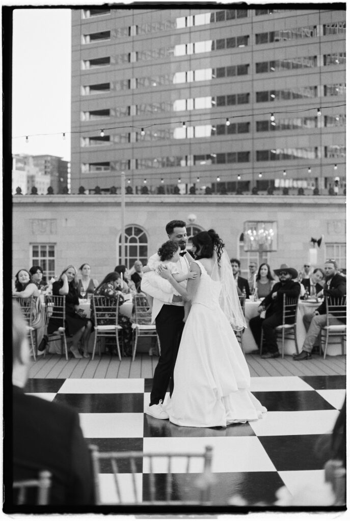 Film wedding photography of bride and groom on a checkered dance floor