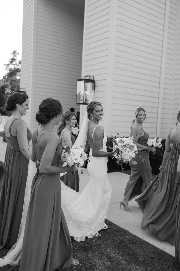 Bride walks with her bridesmaids