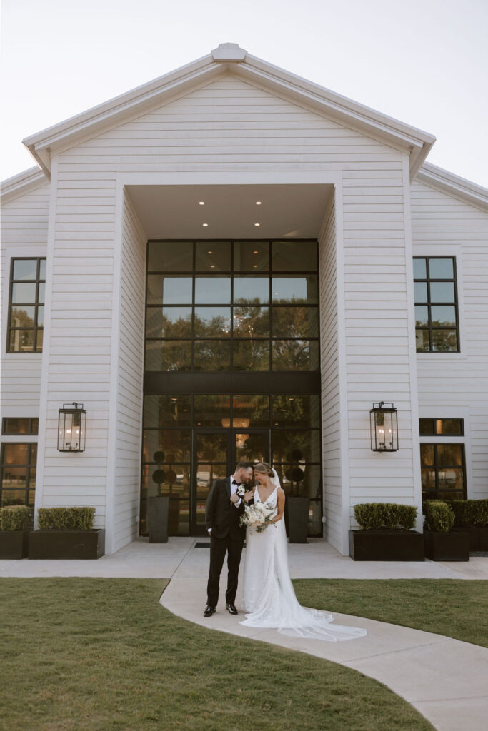 Bride and groom take portraits outside of Boxwood Manor