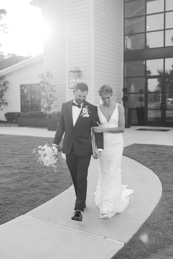 Bride and groom take portraits outside of Boxwood Manor