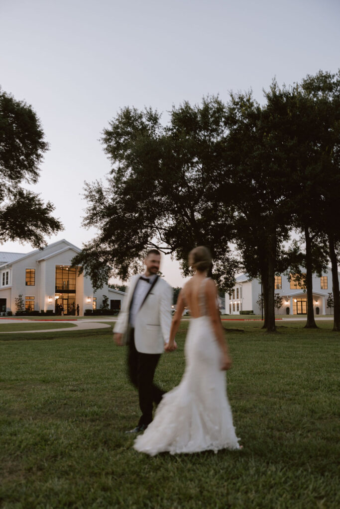 Bride and groom take portraits outside of Boxwood Manor
