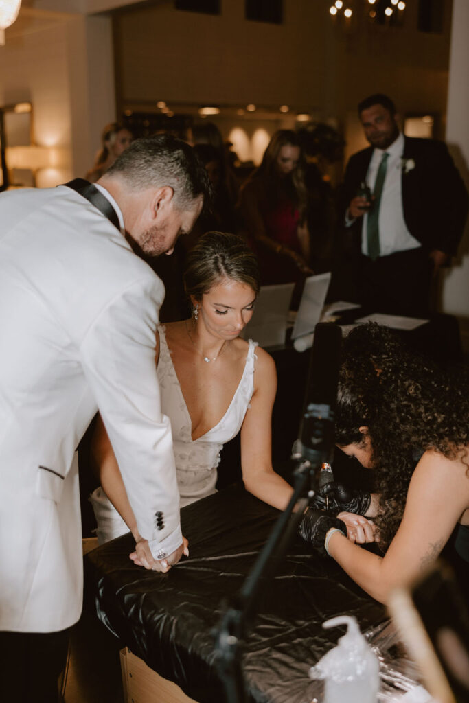 Bride and groom get tiny tattoos at their Boxwood Manor wedding reception