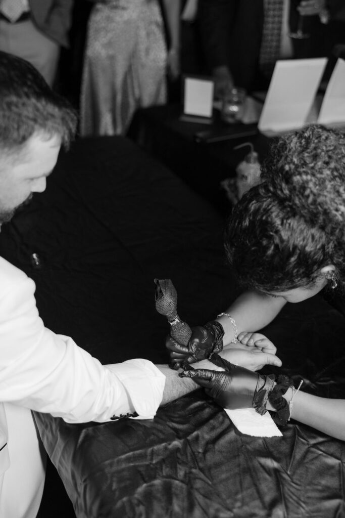 Bride and groom get tiny tattoos at their Boxwood Manor wedding reception