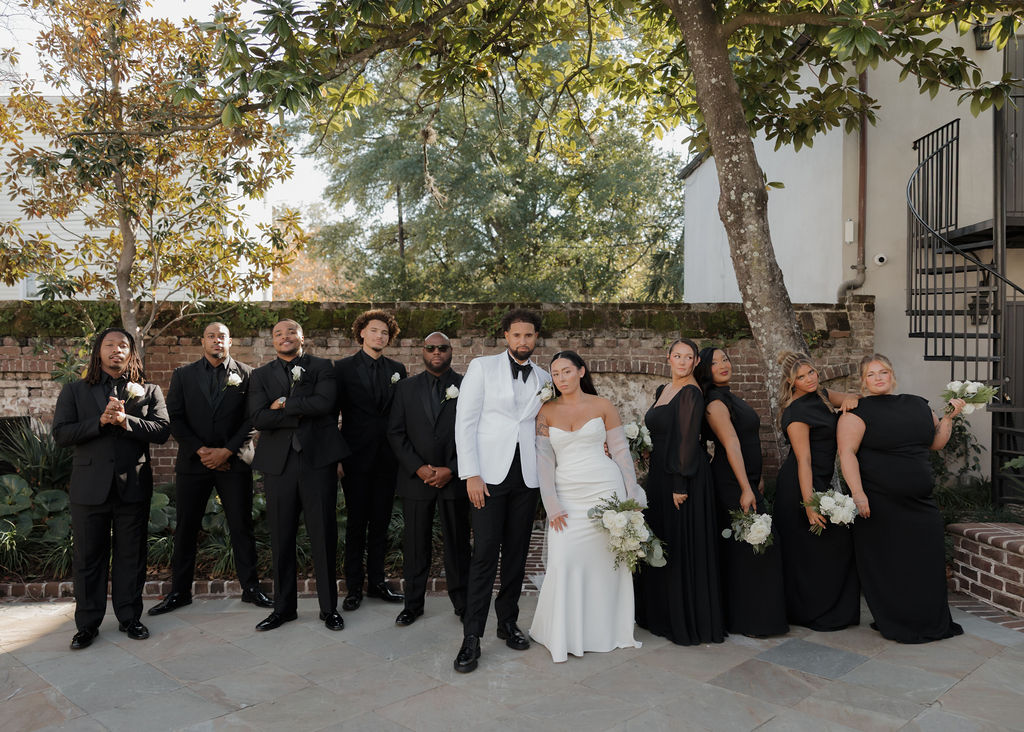 Bride and groom with their wedding party wearing black and white at Gadsden House