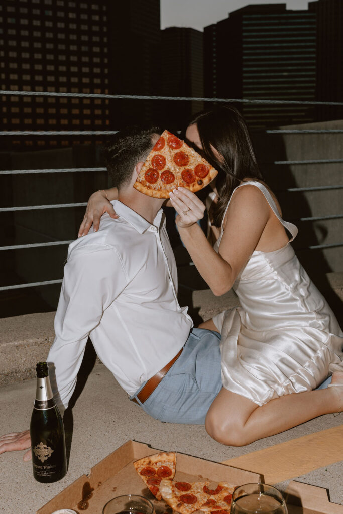 Rooftop engagement photos with pizza in downtown Dallas