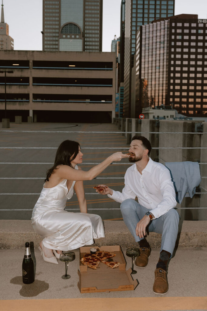 Rooftop engagement photos with pizza in downtown Dallas