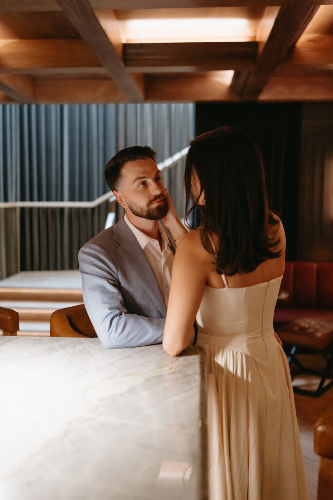 Moody, romantic engagement photos in Dallas at a speakeasy