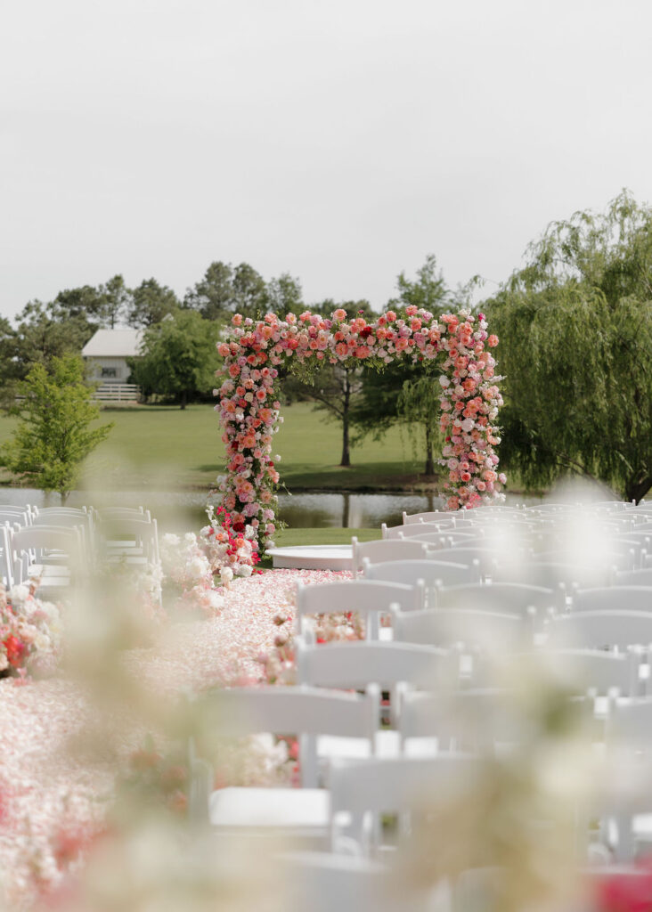 Pink floral arch for a wedding ceremony at The Bower Venue