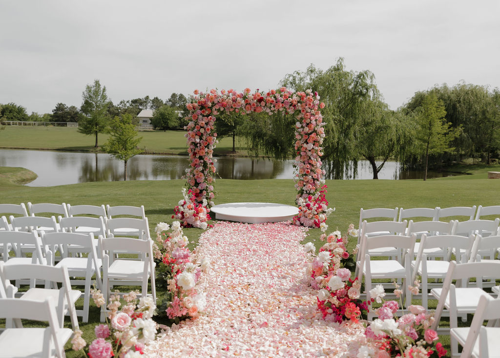 Pink floral arch for a wedding ceremony at The Bower Venue