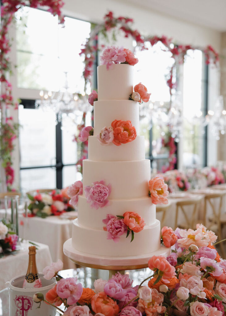 Pink florals on a 6-tiered white wedding cake