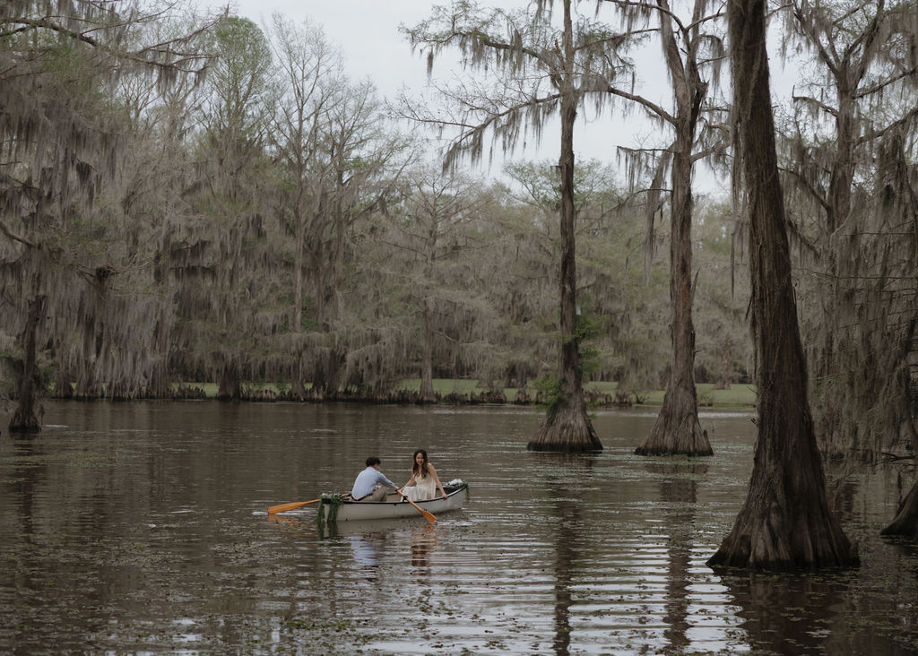 Couple rides in a canoe through Caddo Lake