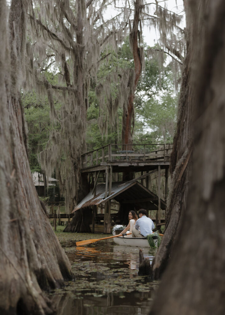Couple rides in a canoe through Caddo Lake
