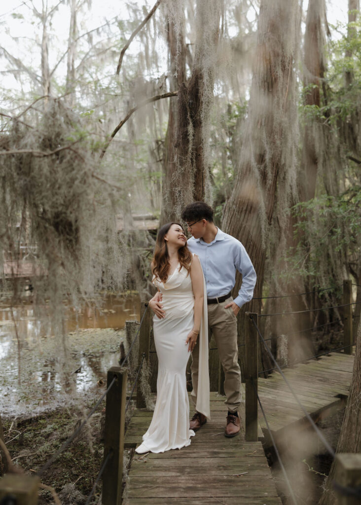 Moody lake engagement photos in Texas with moss covered cypress trees in the backdrop
