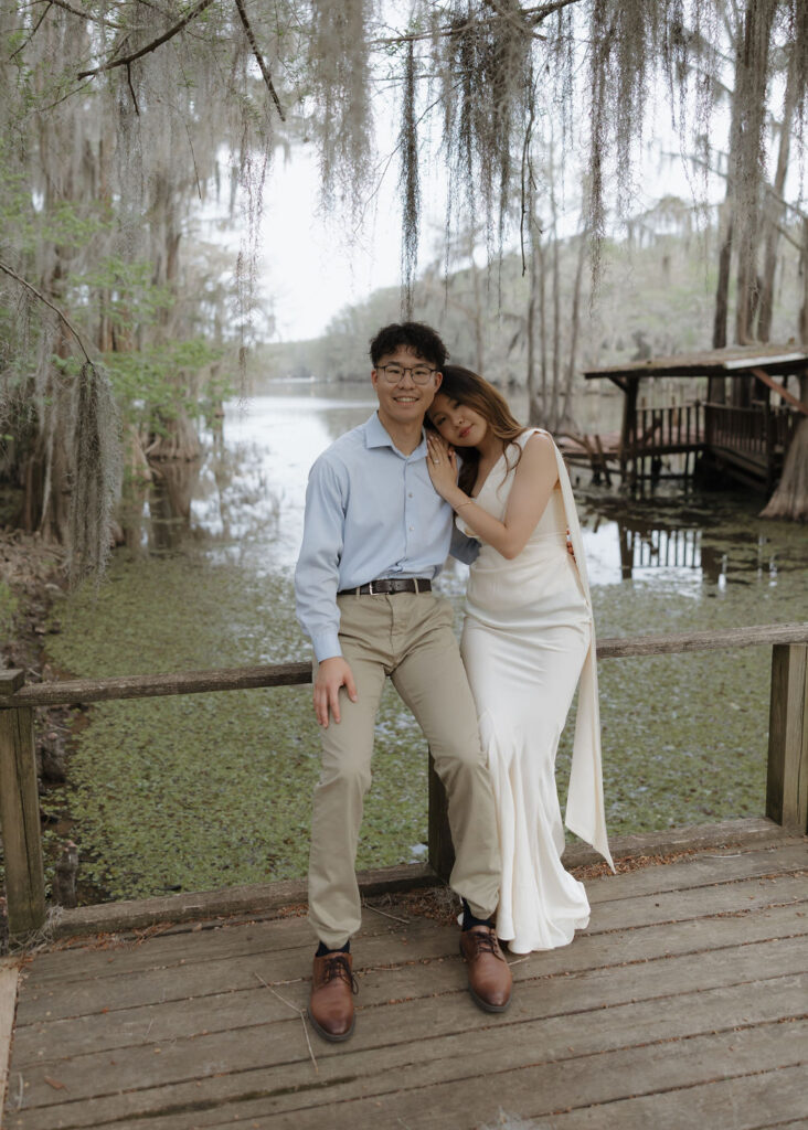 Moody lake engagement photos in Texas with moss covered cypress trees in the backdrop