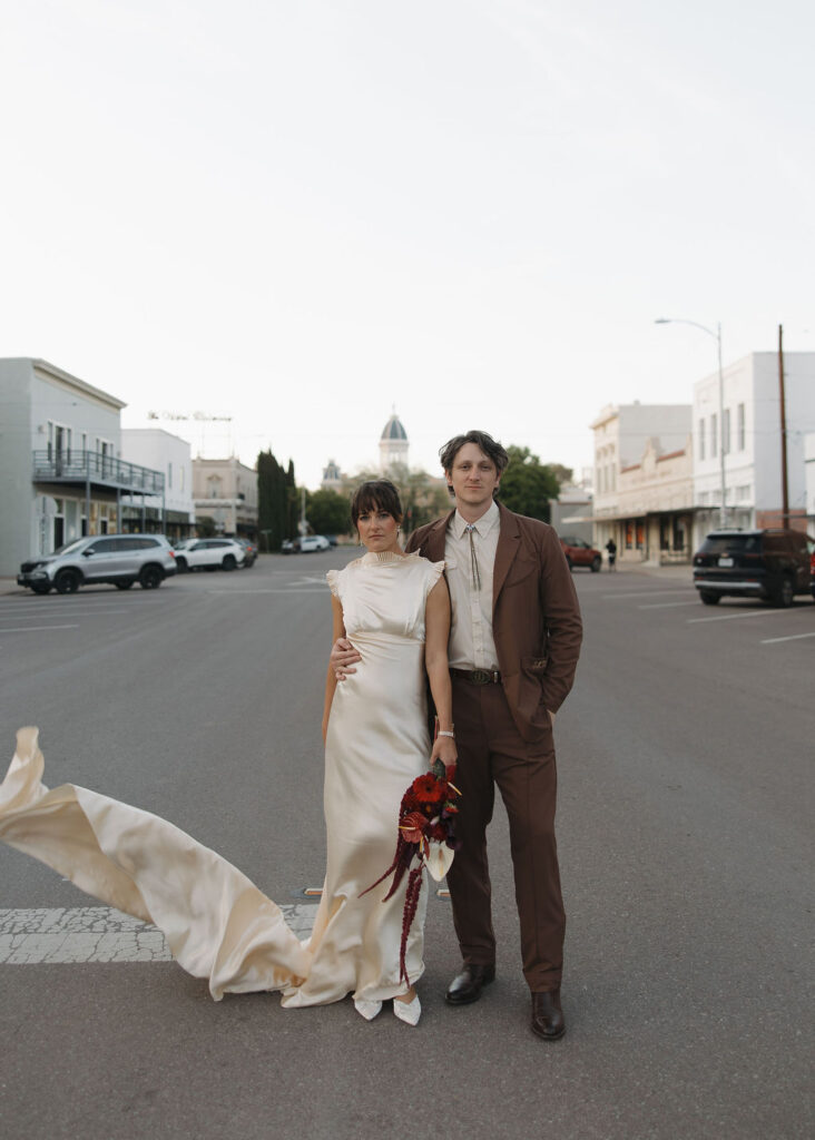 Bride and groom standing in the street in Marfa, Texas
